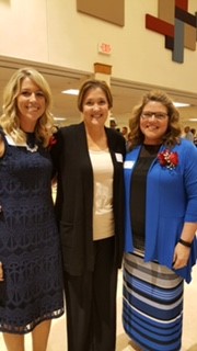 three women smiling and posing for camera